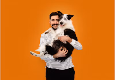 A man holding a big scruffy dog in his arms
